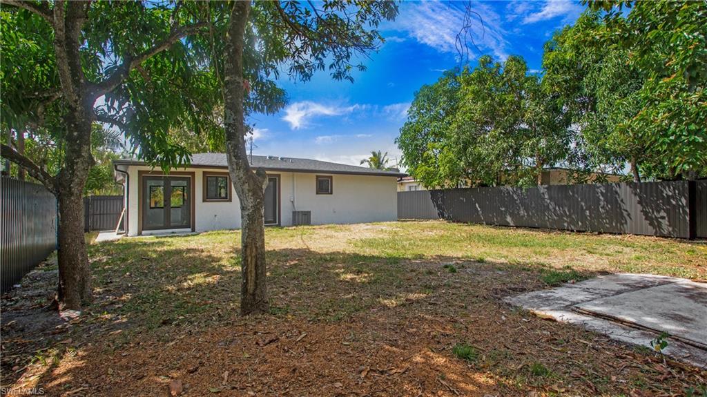 5477 Martin Street Naples, FL 34113 - Photo 21 of 21 a view of a house with backyard and tree