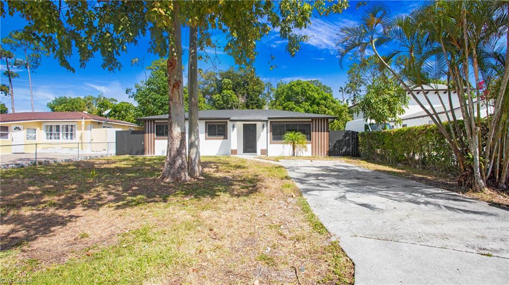 5477 Martin Street Naples, FL 34113 - Photo 3 of 21 front view of a house with a yard