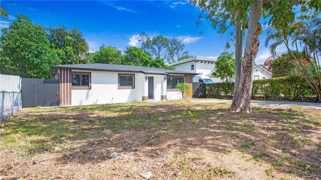 5477 Martin Street Naples, FL 34113 - Photo 4 of 21 a view of a backyard with plants and large tree