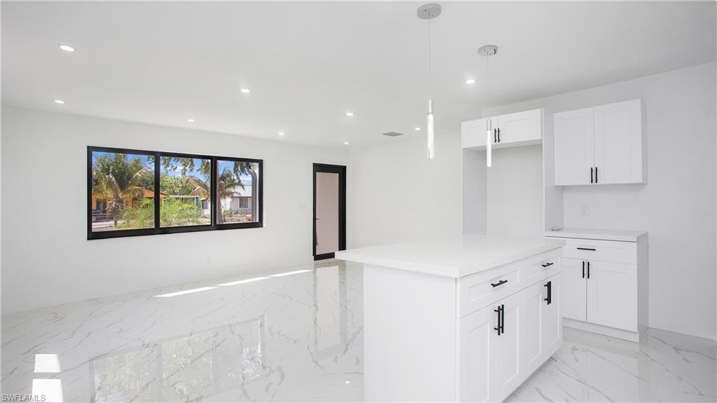 5477 Martin Street Naples, FL 34113 - Photo 6 of 21 a kitchen with stainless steel appliances a refrigerator and a stove