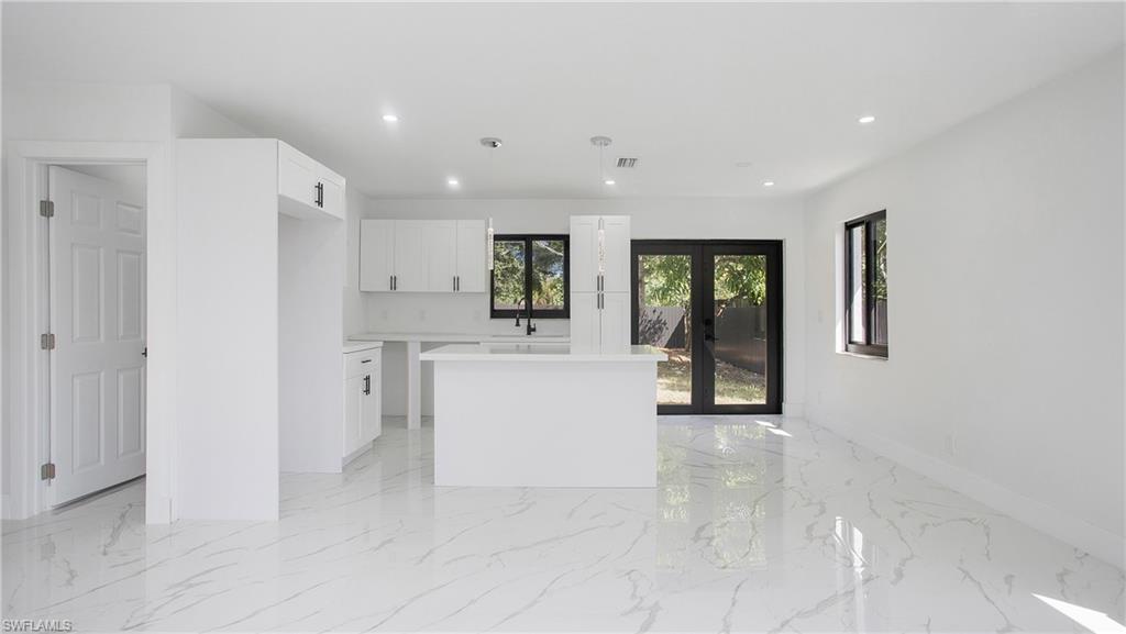 5477 Martin Street Naples, FL 34113 - Photo 8 of 21 a view of a kitchen with a sink and cabinets