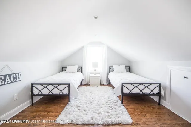 a bedroom with two beds and a table