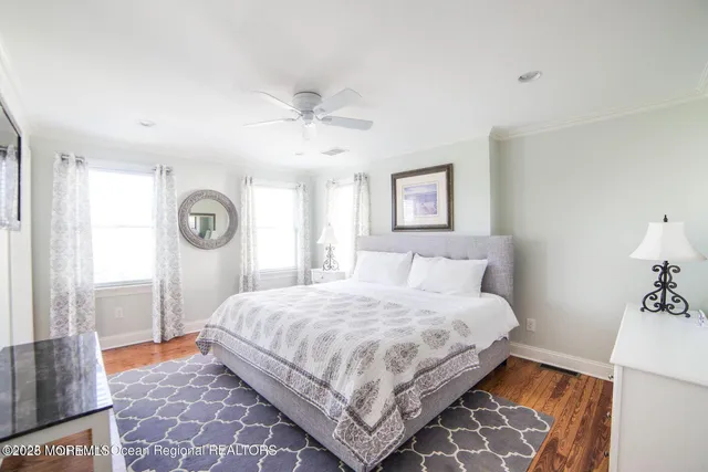a bedroom with a bed and a lamp on dresser