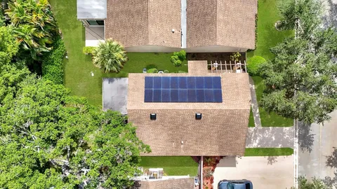 an aerial view of a house with a garden and plants