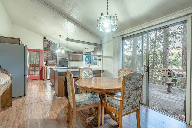 a dining room with furniture a chandelier and wooden floor