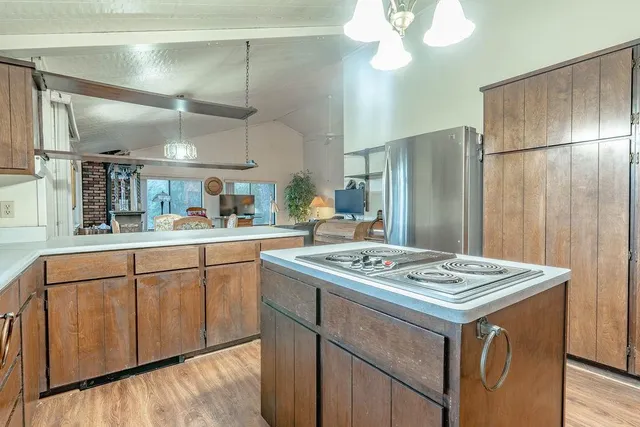 a kitchen that has a stove a table and chairs