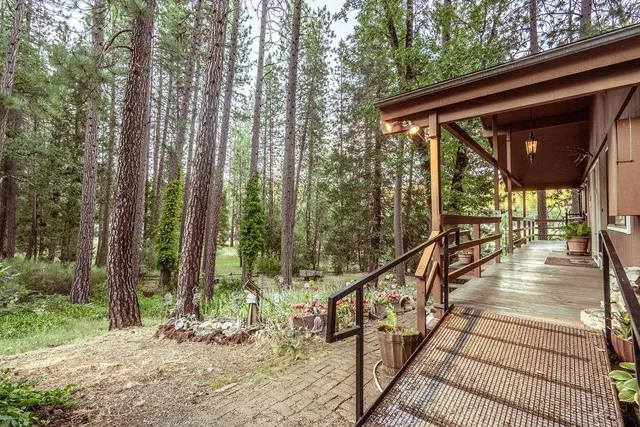 a view of a wooden deck and trees