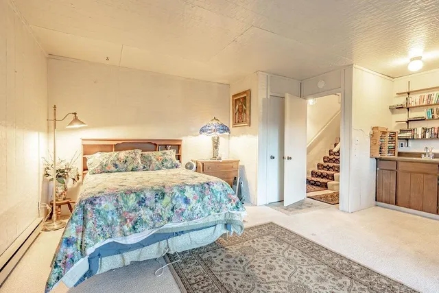 a bedroom with a large bed and a chandelier