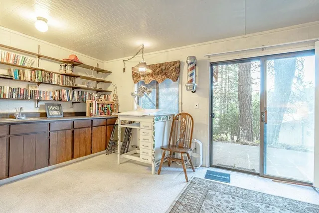 a view of a bedroom with bed and wooden floor