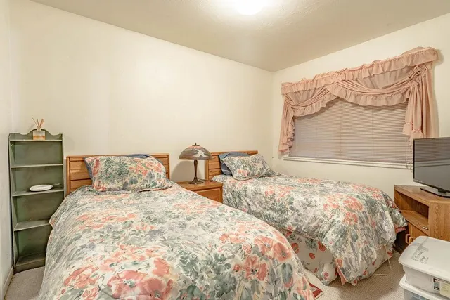 a bedroom with a large bed and a large mirror