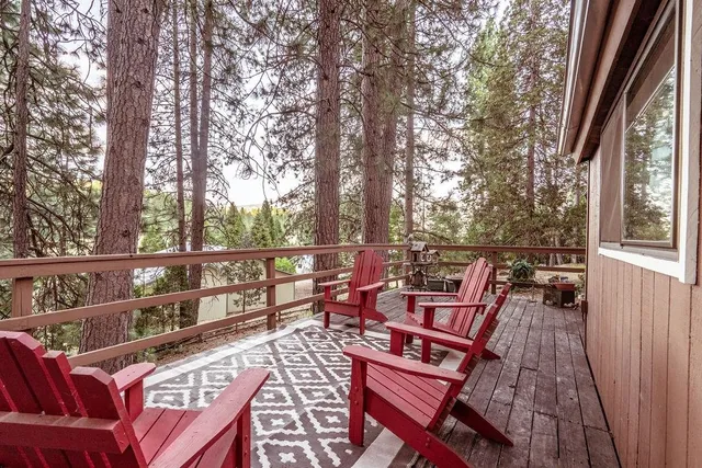 a view of a balcony with wooden floor and outdoor seating