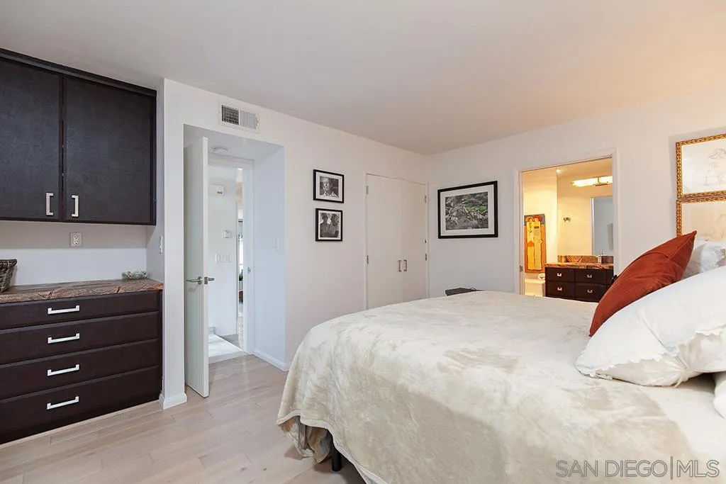 940 Sealane Drive, Unit 3 Encinitas, CA 92024 - Photo 12 of 23 a bed room with a bed and a dresser