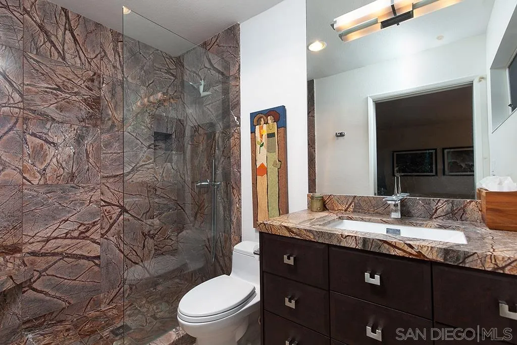 940 Sealane Drive, Unit 3 Encinitas, CA 92024 - Photo 13 of 23 a bathroom with a granite countertop sink toilet mirror and shower