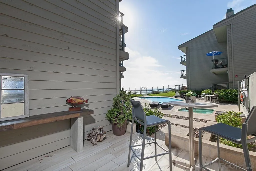 940 Sealane Drive, Unit 3 Encinitas, CA 92024 - Photo 17 of 23 a roof deck with table and chairs and potted plants