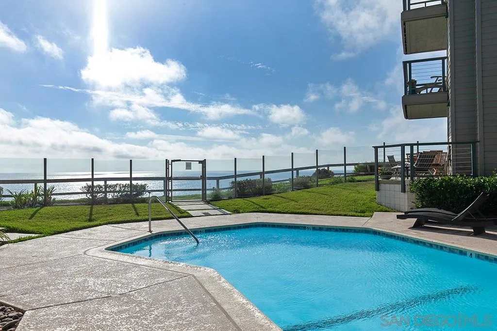 940 Sealane Drive, Unit 3 Encinitas, CA 92024 - Photo 21 of 23 a view of swimming pool with lawn chairs and a yard
