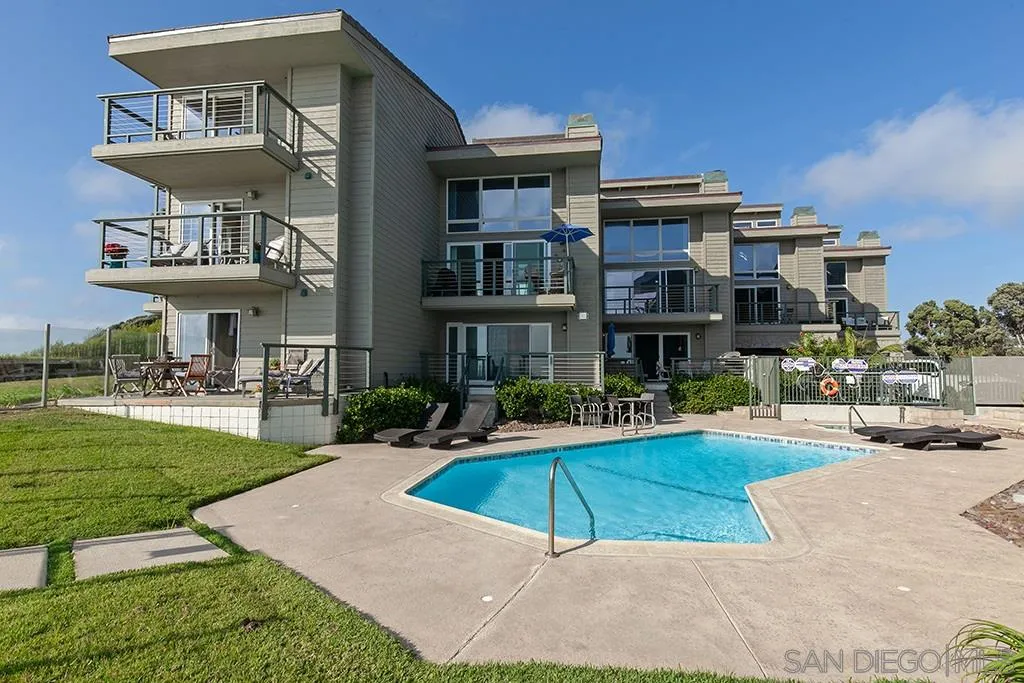940 Sealane Drive, Unit 3 Encinitas, CA 92024 - Photo 22 of 23 a view of a building with a yard