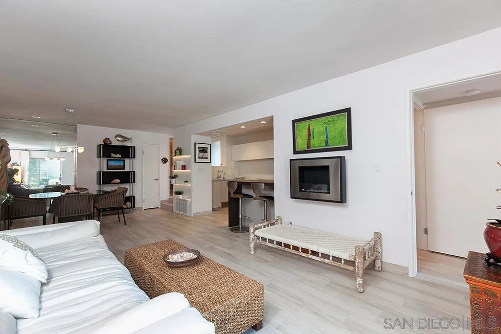 940 Sealane Drive, Unit 3 Encinitas, CA 92024 - Photo 4 of 23 a living room with furniture flat screen tv and a fireplace