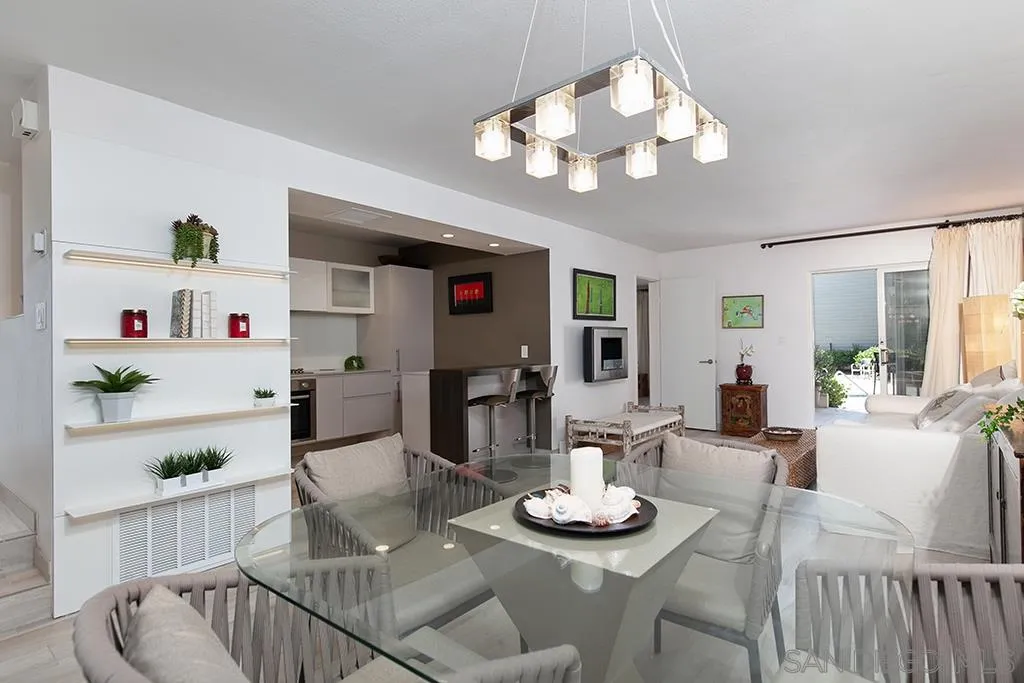 940 Sealane Drive, Unit 3 Encinitas, CA 92024 - Photo 7 of 23 a view of a dining room with furniture a chandelier and wooden floor