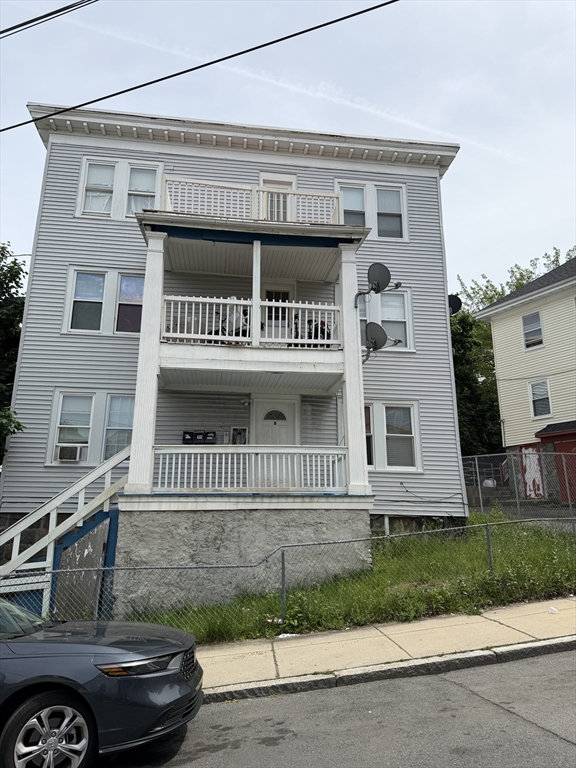 8 Ogden Street Boston, MA 02124 - Photo 2 of 20 a front view of a house with a garden