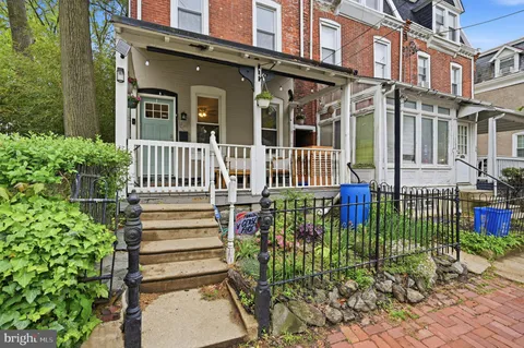 an outdoor view of a house with a garden