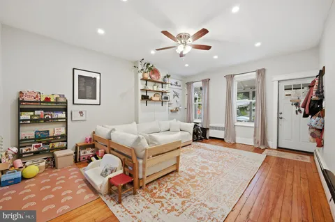 a bedroom with furniture and a wooden floor
