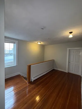 a view of wooden floor and windows in a room