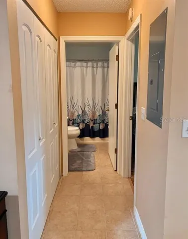 a bed sitting in a spacious bedroom next to a window