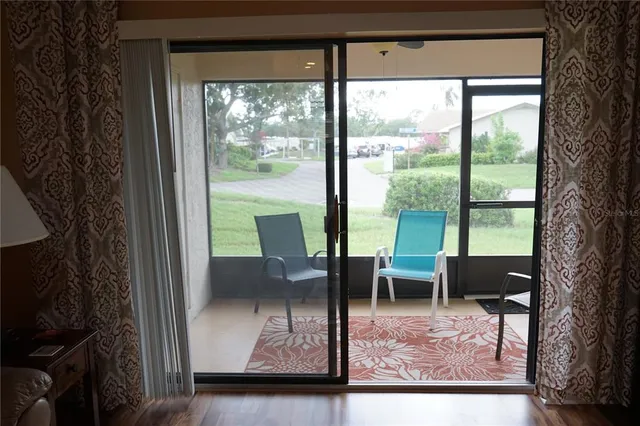 a view of two chairs in a room next to a window