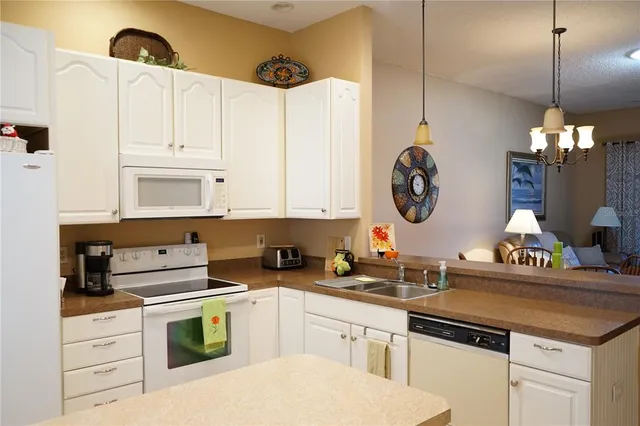 a kitchen with a stove cabinets and window