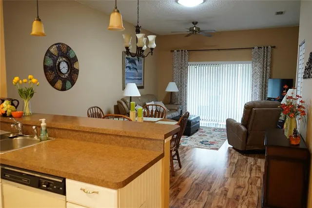 a living room with a table chairs and a wooden floor