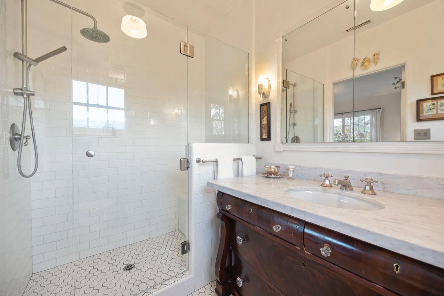 520 Foothill Road Ojai, CA 93023 - Photo 32 of 45 a bathroom with a shower sink double vanity and a mirror