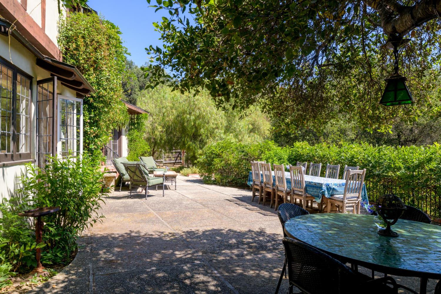 520 Foothill Road Ojai, CA 93023 - Photo 4 of 45 a view of a patio with table and chairs and potted plants with large tree