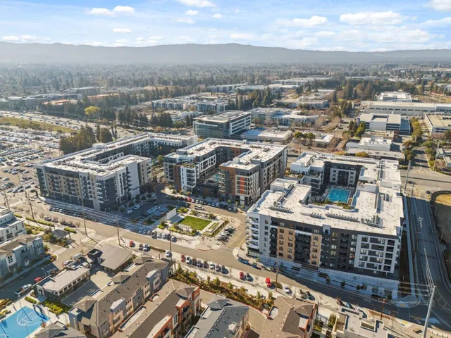 an aerial view of residential houses with outdoor space