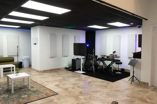 a living room with furniture a flat screen tv and a table