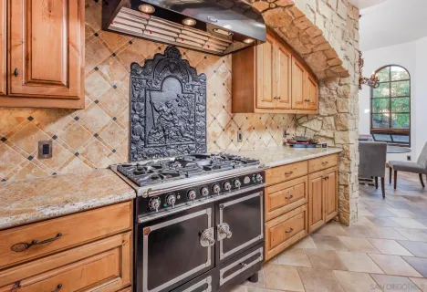 a kitchen with stainless steel appliances granite countertop a stove and a sink