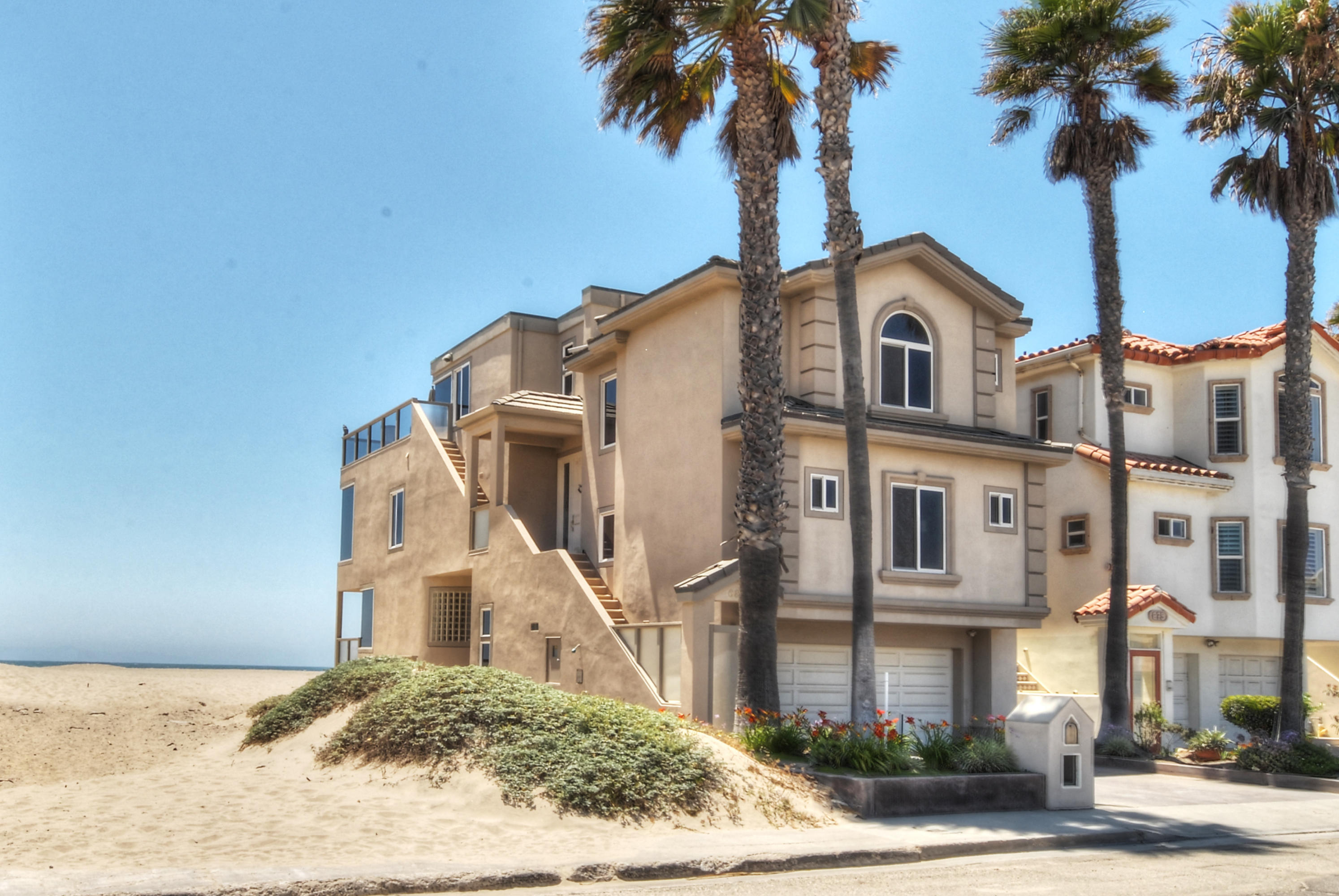 681 Mandalay Beach Road Oxnard, CA 93035 - Photo 1 of 39 a front view of a house with a yard and garage