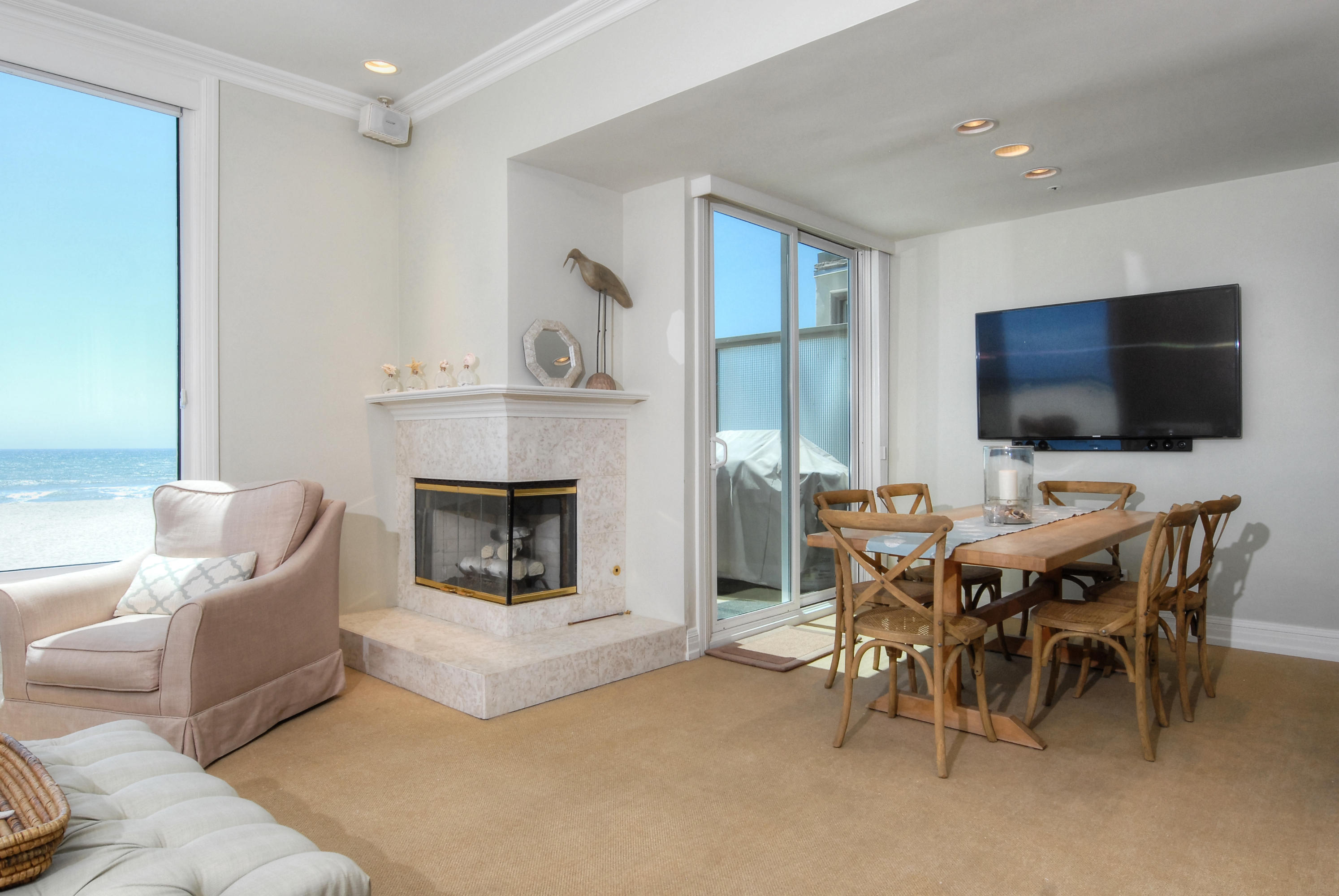 681 Mandalay Beach Road Oxnard, CA 93035 - Photo 8 of 39 a living room with furniture a flat screen tv and a fireplace