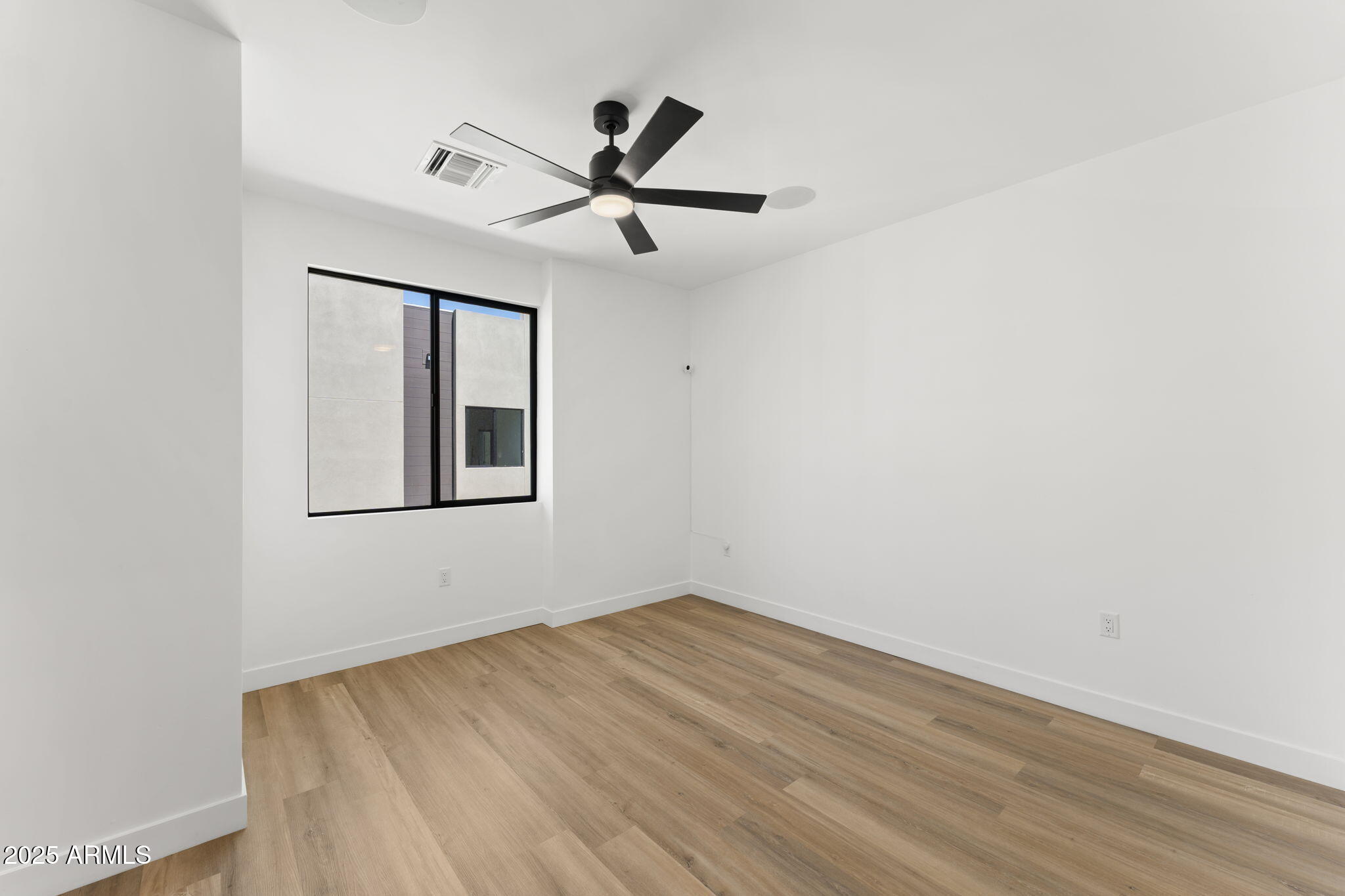 4220 North 32nd Street, Unit 7 Phoenix, AZ 85016 - Photo 21 of 35 a view of empty room with wooden floor and fan