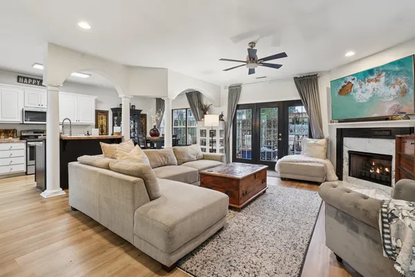 a living room with furniture fireplace and flat screen tv