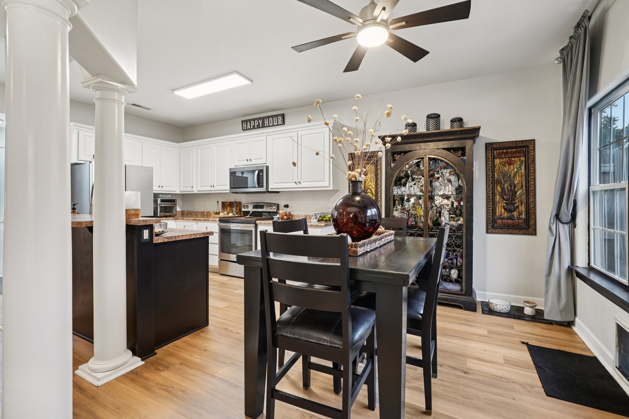 2521 Pennington Bend Road, Unit 206 Nashville, TN 37214 - Photo 10 of 34 a kitchen with stainless steel appliances kitchen island granite countertop a refrigerator a stove a microwave oven a dining table and chairs with wooden floor