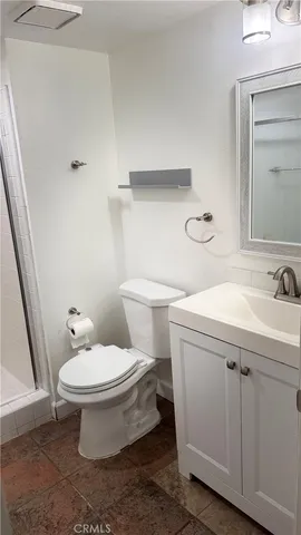 a white toilet sitting next to a bathroom sink