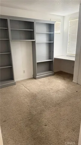 a view of an empty room with a fireplace