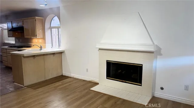a kitchen with granite countertop a stove and a fireplace