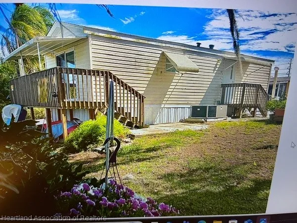 a view of a house with a yard and sitting area
