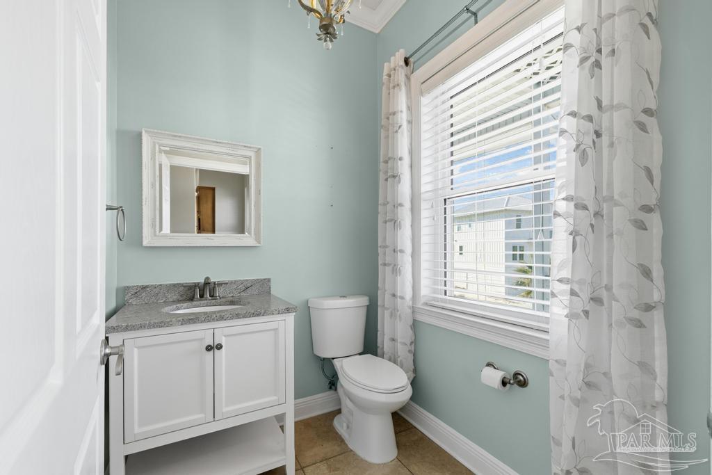 321 Gulfview Lane Perdido Key, FL 32507 - Photo 14 of 57 a bathroom with a granite countertop toilet a sink and a window