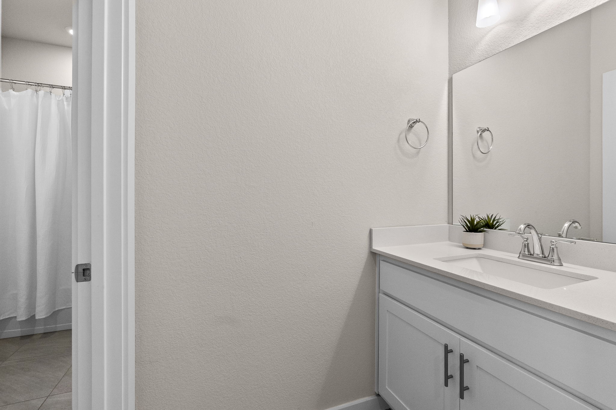 460 Constitution Way Kyle, TX 78640 - Photo 28 of 40 White vanity with an integrated rectangular sink and polished chrome faucet