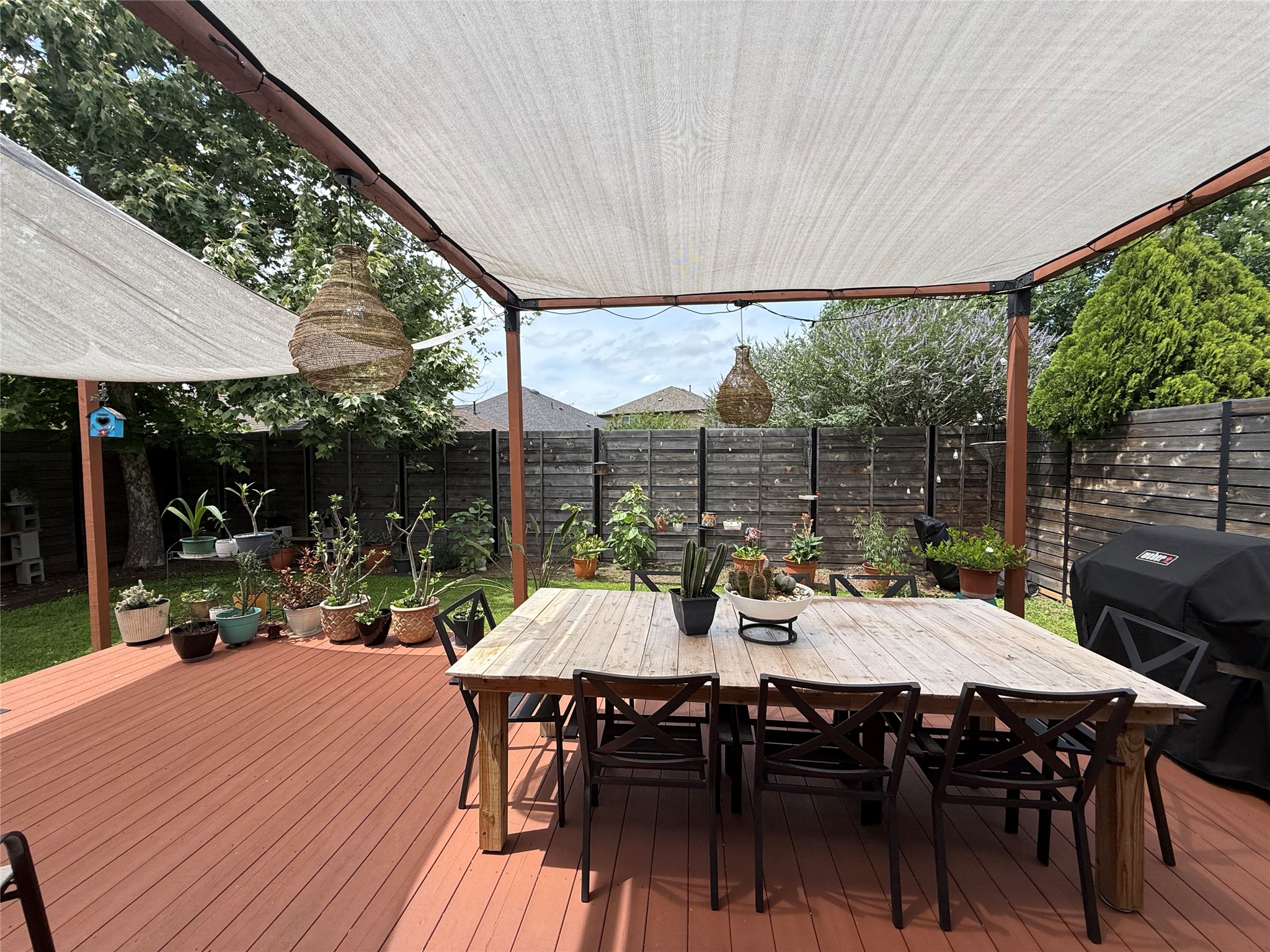 7108 Hester Road Austin, TX 78725 - Photo 14 of 25 a view of a patio with a table chairs and a backyard