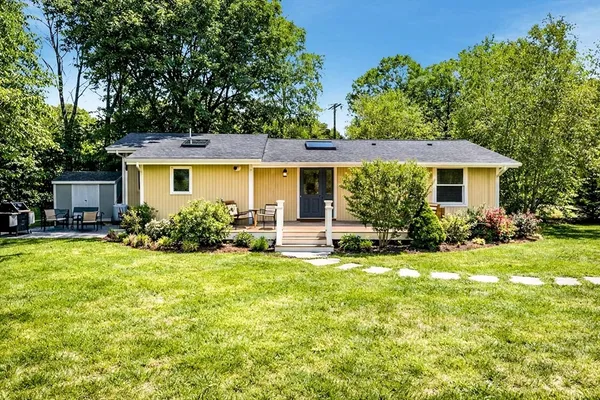 a front view of house with yard and green space