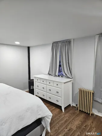 a bedroom with a bed and wall painting