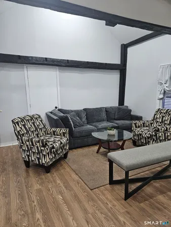 a kitchen with granite countertop a sink a stove and cabinets